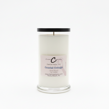 Coastal Cottage Soy Candle in a clear glass jar with a black lid, offering a beachside sanctuary scent experience.