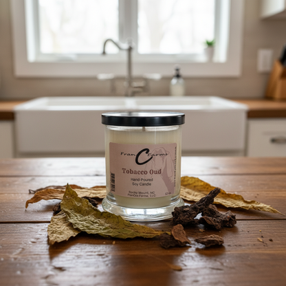 Tobacco Oud Soy Candle - 12 oz. jar displayed with natural elements on a wooden table.