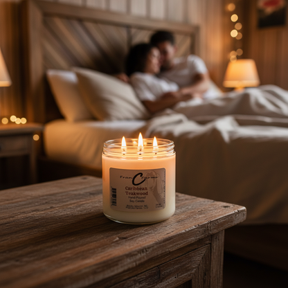 Caribbean Teakwood Soy Candle on a bedside table with a couple relaxing in bed, showcasing the warm glow of the candle.