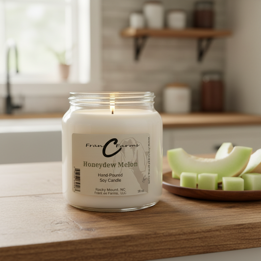 Honeydew Melon Soy Candle in an 18 oz. apothecary jar on a wooden table with melon slices.