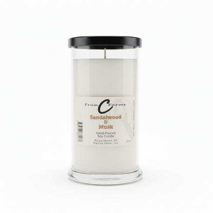Sandalwood & Musk Soy Candle - 22 oz. Hand poured in a clear jar with a black lid for a warm, earthy ambiance.