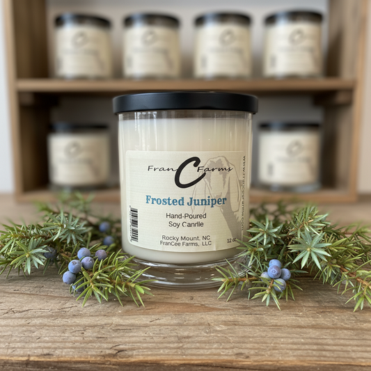 Frosted Juniper Soy Candle - 12 oz. status jar with fresh evergreen accents and a rustic background.