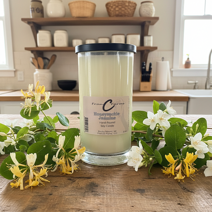 Honeysuckle Jasmine Soy Candle in a glass jar surrounded by honeysuckle flowers, showcasing a floral and sweet aroma.
