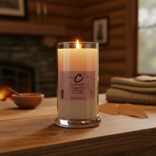 Caribbean Teakwood soy candle in a glass jar, ambiance with a cozy fireplace and folded towels.