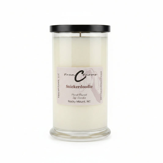 Snickerdoodle Soy Candle in a clear status jar with a black lid, featuring a label displaying its name and origin.