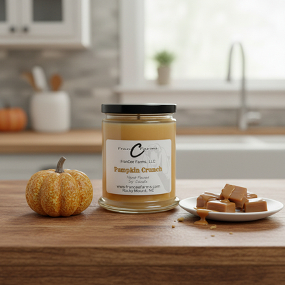 Pumpkin Crunch Soy Candle - 12 oz. jar with caramel pieces and a pumpkin in a rustic kitchen setting.