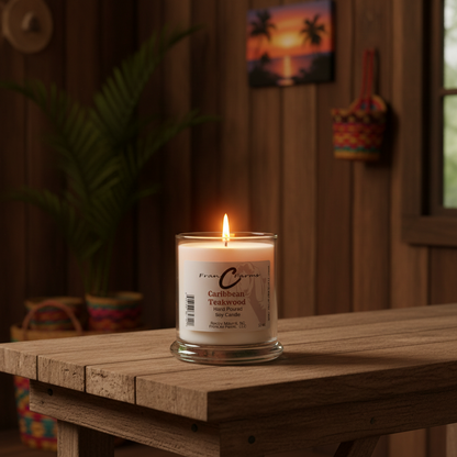 Caribbean Teakwood soy candle burning on a wooden table, surrounded by tropical decor and plants.
