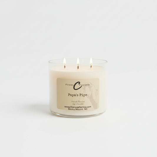 Papa's Pipe soy wax candle in a clear jar with three wicks, labeled for its warm, nostalgic fragrance.