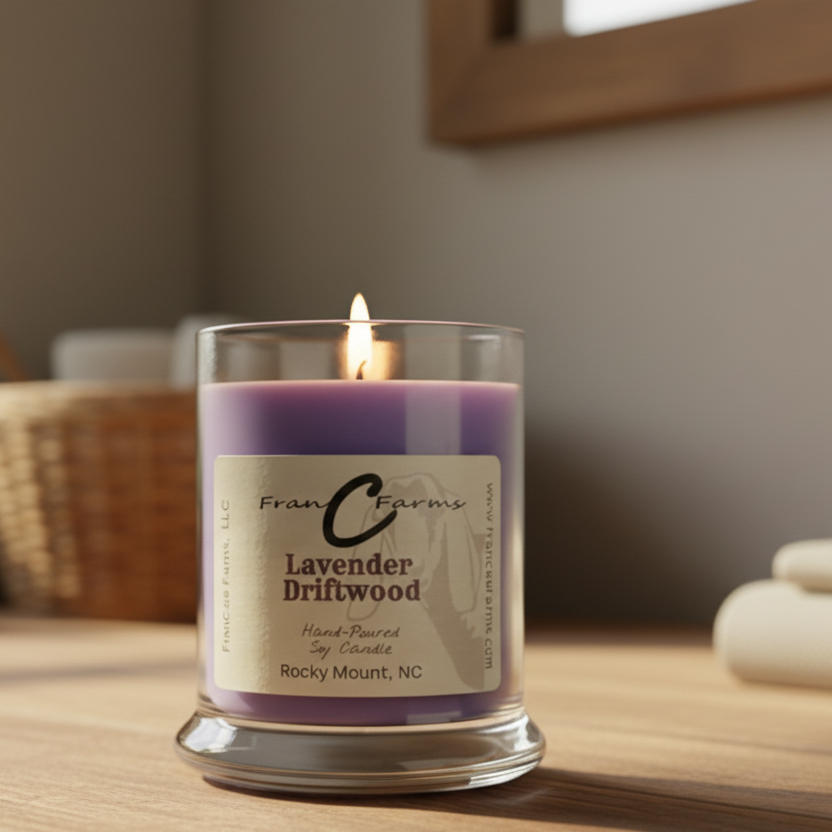 Lavender Driftwood Soy Candle in a glass jar, hand-poured, with a lit wick on a wooden table.