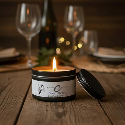 Ocean Breeze Soy Candle Tin glowing on a table, surrounded by wine glasses and elegant dining setup.