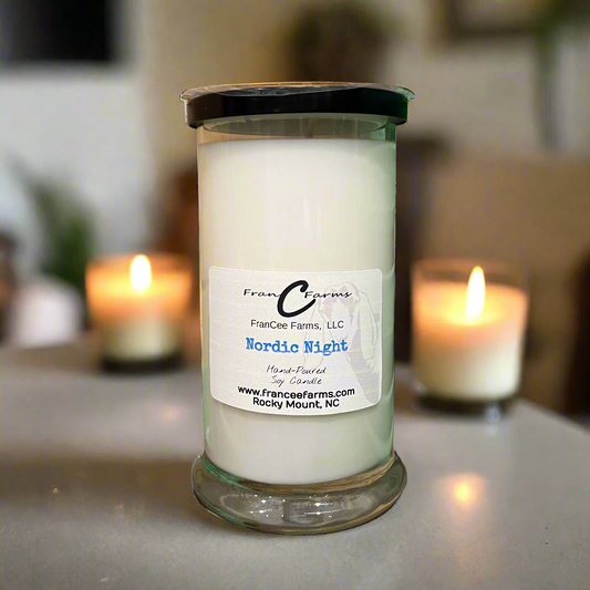 Nordic Night soy candle in a glass jar with soft candlelight in the background, capturing a cozy ambiance.